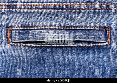 Texture backdrop photo of blue colored denim cloth with seam and pocket. Stock Photo