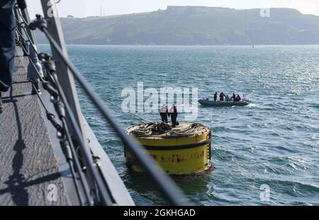 PLYMOUTH, England (April 23, 2021) Sailors aboard the Arleigh Burke-class guided-missile destroyer USS Ross (DDG 71) moor the ship to a buoy in Plymouth, England during Flag Officer Sea Training (FOST), April 23, 2021. FOST is a three-week exercise led by the Royal Navy that tests the ship’s warfighting ability. Ross, forward-deployed to Rota, Spain, is on patrol in the U.S. Sixth Fleet area of operations in support of regional allies and partners and U.S. national security interests in Europe and Africa. Stock Photo