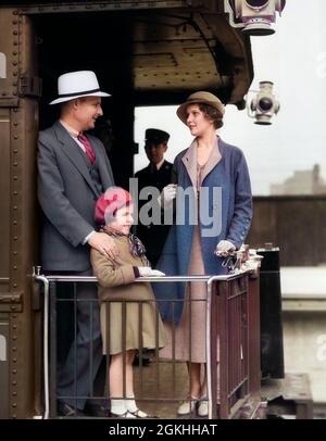 1930s FAMILY OF THREE STANDING ON BACK PLATFORM OF PASSENGER TRAIN PARLOR OBSERVATION CAR WITH CONDUCTOR TRAINMAN IN BACKGROUND - r6010c HAR001 HARS 3 DAD FOUR TRAVEL MOM HATS CLOTHING NOSTALGIC RAILWAY PAIR 4 COLOR RELATIONSHIP MOTHERS OLD TIME NOSTALGIA TRAINS OLD FASHION 1 JUVENILE BOARDING VACATION RAILROAD FAMILIES LIFESTYLE PARENTING FEMALES VERTICAL PASSENGERS MARRIED RELATION PORTRAITS SPOUSE HUSBANDS GROWNUP LUXURY PASSENGER COPY SPACE FULL-LENGTH LADIES DAUGHTERS PERSONS MALES TRANSPORTATION FATHERS MEN AND WOMEN PARTNER TIME OFF HAPPINESS ADVENTURE TRIP GETAWAY DADS RAILING HOLIDAYS Stock Photo