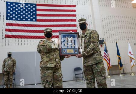 U.S. Army Command Sgt Maj. Marc Maynard, the outgoing CSM of the 106th Regiment (Regional Training Institute), receives a gift for his years of honorable service, during a change of responsibility ceremony at Camp Smith Training Site, Cortlandt Manor, N.Y., April 24, 2021. Stock Photo