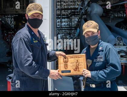 US Navy Engineman 2nd Class Anthony Bartelli (right) holds an