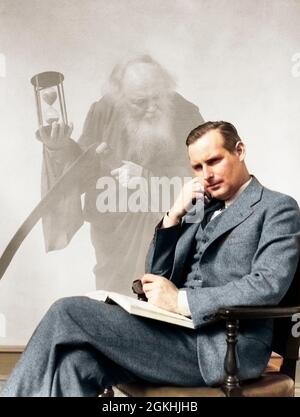 1930s MAN IN SUIT SEATED WITH BOOK IN LAP & PIPE IN HAND WITH PENSIVE LOOK WITH GRIM REAPER GHOSTED IN BACKGROUND - s5462c HAR001 HARS ANGER FEAR GHOST MYSTERY STUDIO SHOT PIPE GROWNUP SEATED HOURGLASS HALF-LENGTH PENSIVE END PERSONS MALES FATHERS MIDDLE-AGED GHOSTLY SADNESS MIDDLE-AGED MAN LAP SMOKERS PIPES TOBACCO DEATH TOBACCO PIPE SMOKEY AGING COMPOSITE DADS STRESSFUL SMOKER SCYTHE FATHER TIME REAPER ANGEL OF DEATH ELDERLY MAN GHOSTED GRIM END OF LIFE END OF YEAR LAPLAND WORRYING CAUCASIAN ETHNICITY ENDING HAR001 MACABRE NEW YEAR NEW YEARS OLD FASHIONED Stock Photo