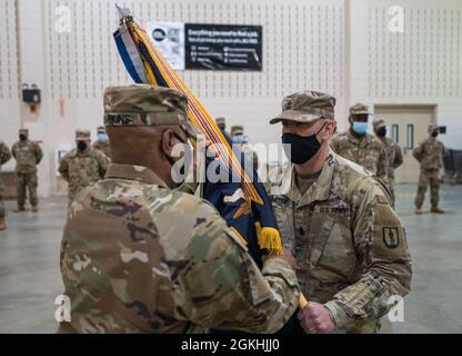 U.S. Army Command Sgt Maj. Andrew Lampkins, the incoming CSM of the 106th Regiment (Regional Training Institute), passes the guidon to the commander of troops during a change of responsibility ceremony at Camp Smith Training Site, Cortlandt Manor, N.Y., April 24, 2021. Stock Photo