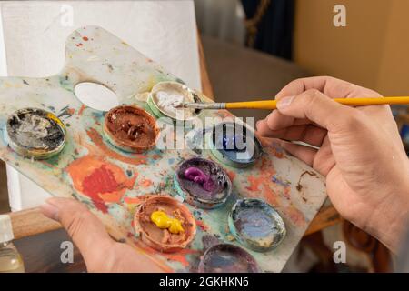 Painting mixing palette art colors and brush Stock Photo - Alamy