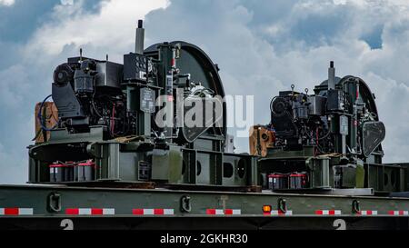 Two Barrier Arresting Kits sit on a trailer on the flight line at Andersen Air Force Base, Guam, April 26, 2021. According to the technical order, BAK-12s are overhauled and replaced every ten years. The BAK-12 feeds a cable across the flight line and, in the case of an in-flight emergency, acts as a mechanical barrier that rapidly decelerates a landing aircraft. Stock Photo