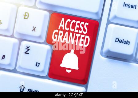 Writing displaying text Access Granted. Word for admittance of users to system and network resources Entering Image Keyword And Description, Typing Stock Photo
