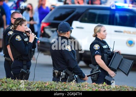 Hostage and Negotiation Tactic officers speak to demonstrators gather near Long Beach City College to protest a Vote No rally for Gavin Newsom, attend Stock Photo