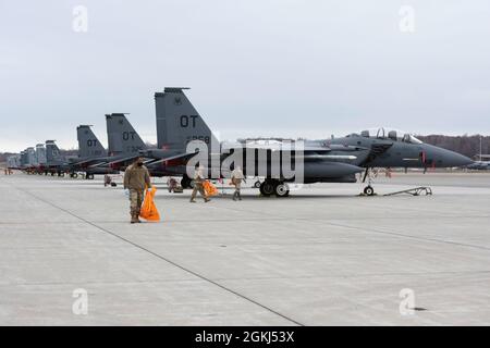 Airmen assigned to the 3rd Wing conduct a foreign object debris walk on the flightline at Joint Base Elmendorf-Richardson, Alaska, April 29, 2021. Active duty Airmen assigned to the 3rd Wing, Reserve Airmen from the 477th Fighter Group and Alaska Air National Guardsmen from the 176th Wing, conducted the FOD walk to remove debris that could potentially damage aircraft and hinder mission readiness. Stock Photo