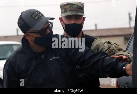 A Soldier assigned to the 1776th Military Police Company, Michigan National Guard, detains a simulated suspect during a law enforcement training at McGregor Range, N.M., April 29, 2021.  Observer, coach and trainers assigned to 5th Armored Brigade, First Army Division West, coached Soldiers with the 1776th MP on how to handle a hostile suspect situation as 5th AR BDE continues to partner with National Guard and Reserve units in all military branches and prepare them to deploy into harm’s way, and return to their families afterwards. Stock Photo