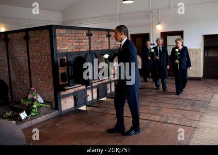 President Barack Obama places a flower at a memorial at Buchenwald Nazi concentration camp, June 5, 2009.  With the President are German chancellor Angela Merkel, and camp survivors Elie Wiesel and Bertrand Herz.  (Official White House Photo by Pete Souza.) This official White House photograph is being made available for publication by news organizations and/or for personal use printing by the subject(s) of the photograph. The photograph may not be manipulated in any way or used in materials, advertisements, products, or promotions that in any way suggest approval or endorsement of the Preside Stock Photo