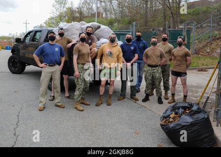 210430-N-EJ843-0125 GROTON, Conn. (April 28, 2021) Members of the Military Working Dog unit, pose for a photo in front of trash bags they filled onboard Naval Submarine Base (SUBASE) New London during a base wide clean-up. The JEA was one of the many organizations to help during a volunteer event focused on environmental cleanliness to recognize Earth Day. Stock Photo