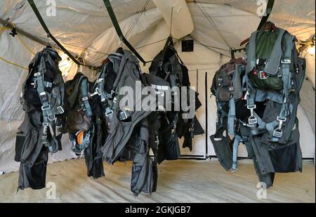 Pilots gear hangs in a tent May 3, 2021 as part of the Agile Flag 21-2 experiment at Naval Outlying Landing Field Choctaw, Florida. Air Combat Command developed the AGILE FLAG 21-2 experiment to create a lead wing, aligning squadrons from different locations under a single commander, enhancing their readiness as a team before deploying into a contested environment. Stock Photo