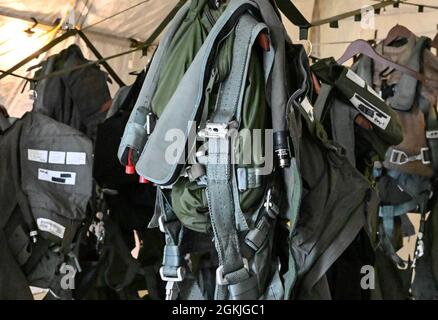 Pilots gear hangs in a tent May 3, 2021 as part of the Agile Flag 21-2 experiment at Naval Outlying Landing Field Choctaw, Florida. Air Combat Command developed the AGILE FLAG 21-2 experiment to create a lead wing, aligning squadrons from different locations under a single commander, enhancing their readiness as a team before deploying into a contested environment. Stock Photo