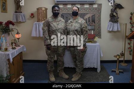 Chaplain (Capt.) Mary Miriti, Post Chaplain, Camp Buehring, Area Support Group Kuwait and Sgt. Seana Ruiz, religious affairs noncommissioned officer in charge, Camp Buehring, Area Support Group Kuwait, stand together for a photo, Camp Buehring Kuwait, May 3, 2021. When Miriti found out she was deploying she asked for Ruiz to be assigned as her religious affairs NCOIC. Stock Photo