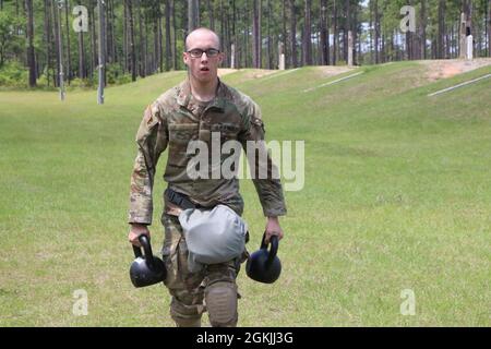 Spc. Gavin Curry, a Soldier assigned to 6th Squadron, 8th Cavalry Regiment, 3rd Infantry Division, sprints with 45 lbs. kettle bells as part of a stress shoot exercise at Small Arms Range Delta during the Division’s Soldier and Noncommissioned Officer of the Year Competition on Fort Stewart, Georgia, May 4, 2021. The stress shoot tested the Soldiers’ ability to fire accurately in spite of being physically stressed. Candidates must outperform all other competitors in both physical and mental toughness as well as technical and tactical knowledge and proficiency to proceed through the corps, majo