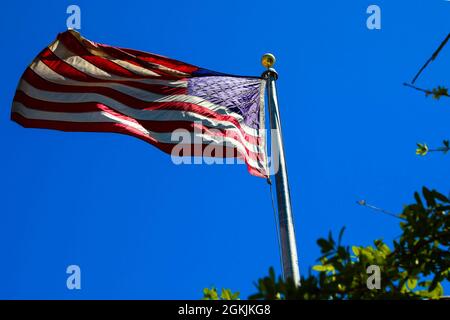 The U.S. Flag waves in the wind at the Cashman Center vaccination site, Wednesday, May 5, 2021 in Las Vegas, Nevada. Joint Task Force 17 personnel assisted in inoculating over 200,000 Nevadans against COVID-19 since vaccine operations began in January of this year. Stock Photo