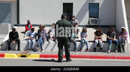 A Big Bend Sector Border Patrol agent answers questions from school-aged children and their teachers visiting from Valentine, Texas, during an open house at U.S. Customs and Border Protection's Big Bend Sector Headquarters, Marfa, Texas, May 5, 2021. Many school-aged children attended the event to learn about the law-enforcement mission CBP agents perform as they live and work within their communities. Faces have been blurred to protect the privacy of the individuals shown. Stock Photo