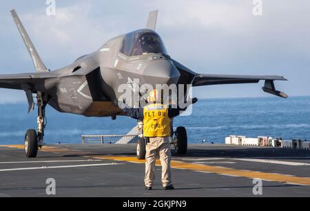 210506-N-LD903-2032  GULF OF ALASKA (May 6, 2021) – U.S. Navy Chief Aviation Boatswain’s Mate (Handling) Andres Bonilla directs an F-35B Lightning II, assigned to Marine Medium Tiltrotor Squadron 164 (Reinforced), 15th Marine Expeditionary Unit, aboard the amphibious assault ship USS Makin Island (LHD 8) in support of Northern Edge 2021. Approximately 15,000 U.S. service members are participating in a joint training exercise hosted by U.S. Pacific Air Forces May 3-14, 2021, on and above the Joint Pacific Alaska Range Complex, the Gulf of Alaska, and temporary maritime activities area. NE21 is Stock Photo