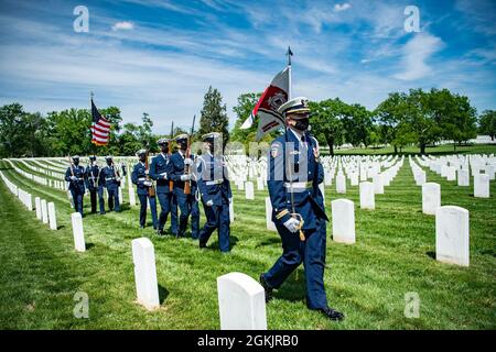 Members of the U.S. Coast Guard Honor Guard, a drummer from the U.S. Navy Ceremonial Band, and the 3d U.S. Infantry Regiment (The Old Guard) Caisson Platoon conduct modified military funeral honors with funeral escort for retired U.S. Coast Guard Rear Adm. Marshall E. Gilbert in Section 33 of Arlington National Cemetery, Arlington, Virginia, May 6, 2021.     Gilbert was a distinguished leader in the U.S. Coast Guard and helped create the technical standards for electronic communications, navigation, and distress alerting used worldwide.       Gilbert's spouse, Melinda Gilbert, received the fla Stock Photo