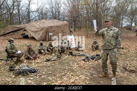 Command Sgt. Maj. Dominic DiFatta, chief culinary management director of the 18th Airborne Corps, talks to 92G Soldiers from Fox Battery Forward Support Company, 2nd Regiment, 15th Field Artillery Battalion, 2nd Brigade Combat Team, 10th Mountain Division (LI) during an after action review at Fort Drum, New York, May 6-7, 2021. The  Soldiers took part in the Philip A. Connelly Awards program, an Army field cooking competition established on March 23, 1968 to recognize excellence in Army culinary services. Stock Photo