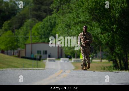 U.S. Army Spc. Ramon Wright, assigned to 3rd Psychological Operations Battalion, 8th Psychological Operations Group, runs toward an event while participating in the Spc. Hilda I. Clayton Best Combat Camera Competition at Fort George G. Meade, Md., May 10, 2021. The Spc. Hilda I. Clayton Best Combat Camera Competition is an annual event hosted by 55th Signal Company (Combat Camera) open to all branches of the military and multi-national partners that tests physical, tactical and technical skills required of visual information specialists. Stock Photo