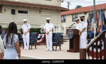 The official party bow their heads during the benediction at the Naval Health Research Center change of command, May 11. Naval Medical Forces Pacific Commander Rear Adm. Tim Weber presided over the ceremony, during which Capt. William Deniston turned over the helm to Capt. Dennis Faix. Stock Photo