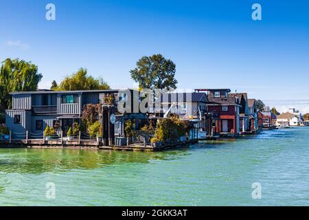 Floating homes along a channel of the Fraser River delta near Ladner British Columbia Canada Stock Photo
