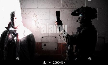 A Marine Raider photographs a simulated detainee during a RAVEN unit readiness exercise in Nashville, Tenn., May 11, 2021. RAVEN is a training exercise held to evaluate all aspects of a Marine Special Operations Company prior to a Marine Forces Special Operations Command deployment. Stock Photo