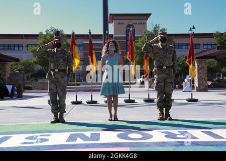 Maj. Gen. Sean Bernabe, senior commander, 1st Armored Division and Fort Bliss, Brig. Gen. Matthew Eichburg, deputy commanding general-operations, and Mrs. Jolene Eichburg render honors during a retreat ceremony in Eichburg's honor at Fort Bliss May 12. After more than two years of service to Fort Bliss, including two separate assumptions of command of the 1st Armored Division, Eichburg departs to become the Chief of Staff, U.S. Army Central Command, Shaw Air Force Base, S.C. Stock Photo