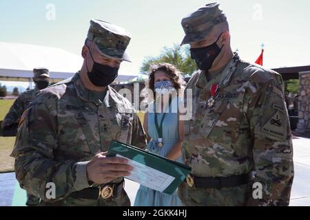 Maj. Gen. Sean Bernabe, senior commander, 1st Armored Division and Fort Bliss, presents the Legion of Merit to Brig. Gen. Matthew Eichburg, deputy commanding general-operations, during a retreat ceremony in Eichburg's honor at Fort Bliss May 12. After more than two years of service to Fort Bliss, including two separate assumptions of command of the 1st Armored Division, Eichburg departs to become the Chief of Staff, U.S. Army Central Command, Shaw Air Force Base, S.C. Stock Photo