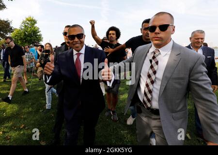 Detroit, Michigan, USA. 14th Sep, 2021. Former Detroit Police Chief JAMES CRAIG, gives a thumbs up as he is escorted by a security detail after being interrupted by protestors when he announced he is a Republican candidate for Governor of Michigan from Belle Isle. (Credit Image: © Jeff Kowalsky/ZUMA Press Wire) Stock Photo