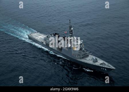 U.S, Australian, French, and Japanese naval assets, to include the Royal Australian Navy’s Anzac-class frigate HMAS Parramatta (FFH 154), the French Navy’s amphibious assault helicopter carrier FS Tonnerre (L9014), and Japan Maritime Self-Defense Force’s Ōsumi class tank landing ship JS Ōsumi, transit together during exercise Jeanne D’Arc 21 (ARC-21), off the coast of Kagoshima, Japan, May 14, 2021. ARC-21 is an opportunity for U.S., French, Japanese and Australian forces to share experiences, tactics, and best practices to sharpen their skills together. Stock Photo