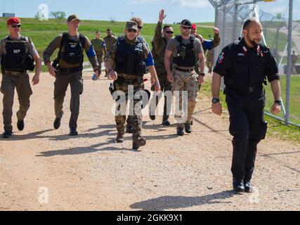 International Military Police members assigned to the NATO-led Kosovo Force march during an MP ruck march at Camp Bondsteel, Kosovo, on May 14, 2021. MPs from across KFOR came together to celebrate National Police Appreciation Week. The week of joint cooperation and training included weapons qualification, obstacle courses, a ruck march and a barbeque. Stock Photo