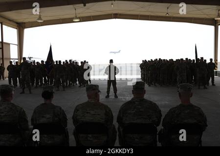 Soldiers of 1st Battalion, 168th Aviation Regiment (General Support Aviation Battalion) (right), and Soldiers of the 2nd Battalion, 104th Aviation Regiment (General Support Aviation Battalion) stand in formation during a Transfer Of Authority ceremony at Camp Buehring, Kuwait. Stock Photo