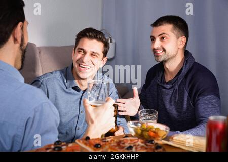 Friendly meeting in men company over beer with pizza Stock Photo