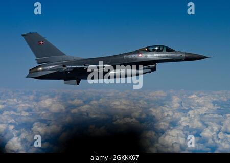 A Danish F-16 escorts a B-52H Stratofortress, assigned to the 96th Bomb Squadron, Barksdale Air Force Base, Louisiana, operating out of Morón Air Base, Spain, on May 19, 2021. Bomber Task Force operations in the European theater allow for interoperability training with NATO allies and partners. Stock Photo