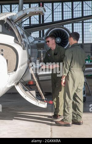 U.S. Marine Corps Capt. David Fickle (Left), a pilot with Headquarters and Headquarters Squadron, performs a pre-flight inspection before boarding a UC-35D Cessna at Marine Corps Air Station Cherry Point, North Carolina, May 18, 2021. Fickle flew for the last time in a UC-35D Cessna before retiring after 20 years of service, four years as an enlisted Marine and 16 years as a Marine officer. The Marine Corps’ history in aviation began 109 years ago with Lt. Alfred A. Cunningham.  Fickle gives us his thoughts on being part of Marine Corps aviation history. “It’s all about our history, going back Stock Photo