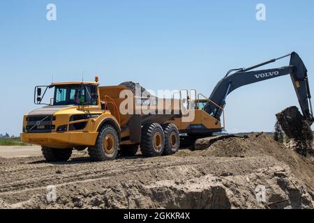 Heavy equipment is used to move recently dredged up sand to other portions of the Craney Island Dredged Material Management Area. The sand, which is being repurposed, was originally placed in the facility from dredging the navigation channels in the Hampton Roads region. The Craney Island facility is a 2,500-acre confined dredged material disposal site located in Portsmouth, VA., and provides a long-term material dredged from the channels and ports in the Hampton Roads area. Stock Photo