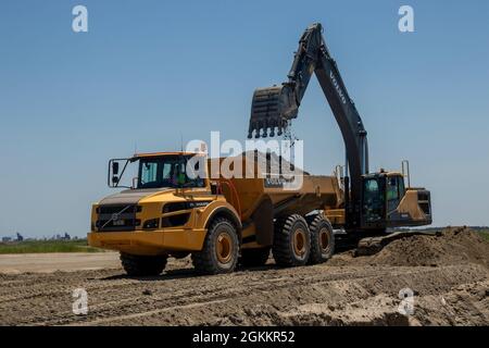 Heavy equipment is used to move recently dredged up sand to other portions of the Craney Island Dredged Material Management Area. The sand, which is being repurposed, was originally placed in the facility from dredging the navigation channels in the Hampton Roads region. The Craney Island facility is a 2,500-acre confined dredged material disposal site located in Portsmouth, VA., and provides a long-term material dredged from the channels and ports in the Hampton Roads area. Stock Photo