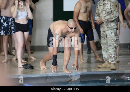 A Soldier representing 6th Squadron, 8th Cavalry Regiment, 2nd Armored Brigade Combat Team, prepares to swim in the swimming relay race during Marne Week May 20, 2021, on Fort Stewart, Georgia. Marne Week displays the fighting spirit, tenacity and warrior ethos that is the Dogface Soldier, carrying on the unit's proud history and lineage.