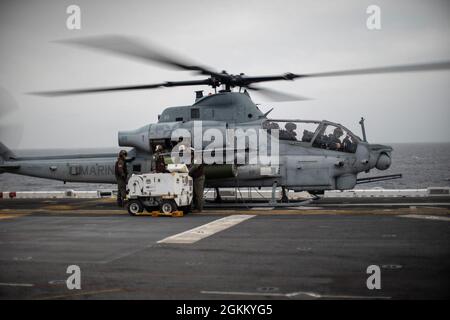 PACIFIC OCEAN (May 20, 2021) U.S. Marines with Marine Medium Tiltrotor Squadron (VMM) 165 (Reinforced), 11th Marine Expeditionary Unit (MEU), ready an AH-1Z Viper for takeoff from amphibious assault ship USS Essex (LHD 2), May 20. Marines and Sailors of the 11th MEU and Essex Amphibious Ready Group (ARG) are underway conducting integrated training off the coast of southern California.