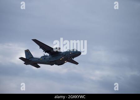 Colombian Air Force A-29B Super Tucano maintainers walk past the ...