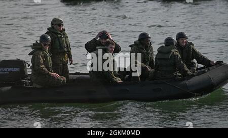 U.S. Marines with Alpha Company, Battalion Landing Team 1/4, 15th Marine Expeditionary Unit, ride in a combat rubber raiding craft after departing the amphibious transport dock ship USS San Diego (LPD 22) at Marine Corps Base Camp Pendleton, California, May 21, 2021. The 15th MEU, returned from a seven-month deployment to the U.S. 3rd, 5th, 6th, and 7th Fleet areas of operation, serving as a crisis-response force for combatant commanders in the Africa, Central and Indo-Pacific commands. Stock Photo