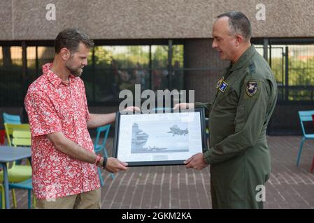 Lt. Gen. Eric Fick, F-35 Joint Program Executive Officer, presents Brett Matthews, F-35 Chief of Staff, with a photo mat during his farewell reception at the program headquarters in Arlington, Va. The F-35 Joint Program Office is the Department of Defense's focal point for the 5th generation strike aircraft for the Navy, Air Force, Marines, and our allies. The F-35 is the premier multi-mission, 5th generation weapon system. Its ability to collect, analyze and share data is a force multiplier that enhances all assets in the battle-space: with stealth technology, advanced sensors, weapons capaci Stock Photo