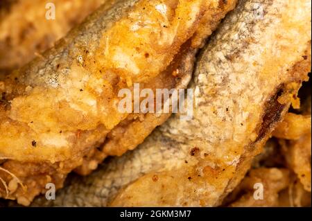 Small fried fish, surface texture, background image, close-up, selective focus Stock Photo