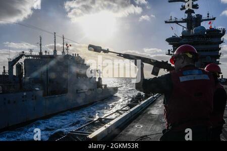 210522-N-RO855-1050    PACIFIC OCEAN (May 22, 2021) – U.S. Navy Gunner’s Mate 2nd Class Tyler Thornton, from Mocksville, N.C., shoots a phone-and-distance line from the aircraft carrier USS Theodore Roosevelt (CVN 71) to the fleet replenishment oiler USNS Richard Byrd (T-AKE 4) during a replenishment-at-sea, May 22, 2021. The Theodore Roosevelt Carrier Strike Group is on a scheduled deployment conducting routine operations in U.S. 3rd Fleet. Stock Photo