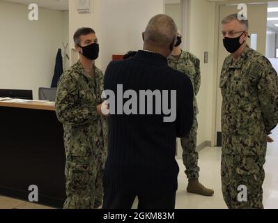 Rear Adm. Tim Weber, Naval Medical Forces Pacific commander, talks with researchers from Naval Medical Research Center who were at Naval Hospital Camp Pendletion's 13 Area clinic, May 24. The research team, which is led by Cmdr. Andrew Letizia, was at the clinic to follow up with Marines participating in the COVID-19 Health Action Response for Marines (CHARM) study. The first part of the study took place last year at Marine Corps Recruit Depot Parris Island during the height of the pandemic. Researchers aim to understand the long-term health impact of COVID-19 infection by following participan Stock Photo