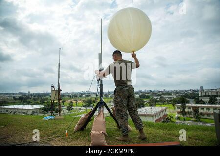 U.S. Marine Corps Cpl. Peter Chang, a Meteorological and Oceanographic forecaster with 3rd Intelligence Battalion, prepares a weather balloon for flight during a training event at Kadena Air Base, Okinawa, Japan, May 25, 2021.  1st Marine Aircraft Wing is improving capabilities to ensure that when our partners and allies need us we will continue to be able to answer the call, as we have in the past. Stock Photo