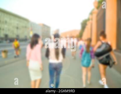 Crowd of blurred walking and talking young people in city. Stock Photo