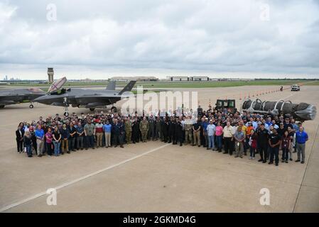Members of the Oklahoma City Air Logistics Complex (OC-ALC) Heavy Maintenance Center pose for a group photo with the Air Force’s F-35A Lightning II Demonstration Team after a demonstration flight at Tinker Air Force Base, Oklahoma, May 25, 2021. The visit and subsequent demonstration flight were provided by Air Combat Command as a show of appreciation for the men and women who support the F-35’s engine maintenance. OC-ALC performs all aspects of engine maintenance on the F135 engine. Stock Photo